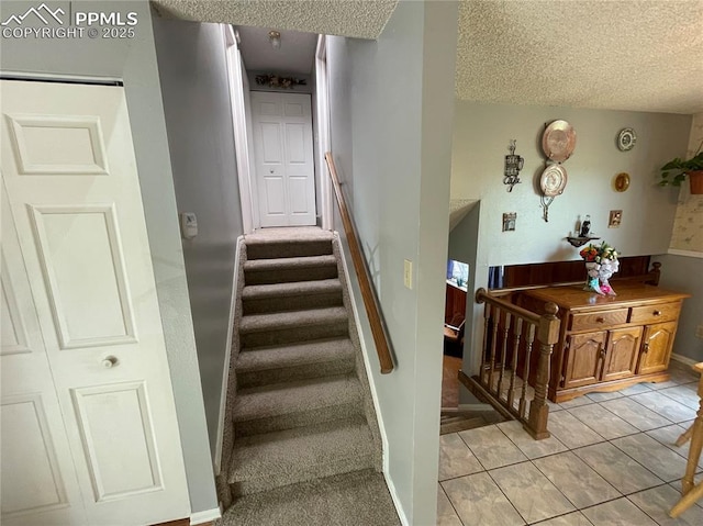 4620 Scenic Cir, Colorado Springs, CO 80917 - stairway with a textured ceiling, tile patterned floors, and baseboards
