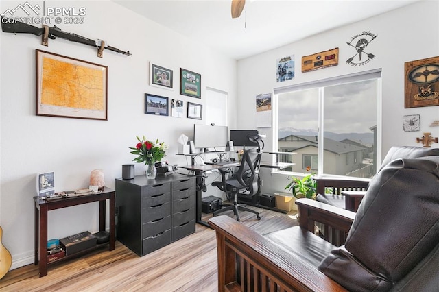 office with light wood finished floors and ceiling fan