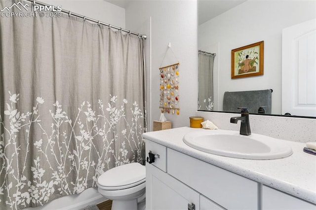 bathroom featuring toilet and vanity