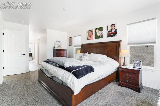 bedroom with carpet floors and baseboards