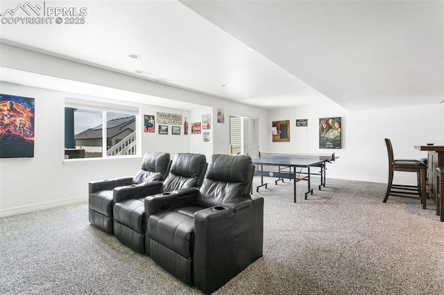 carpeted home theater featuring baseboards