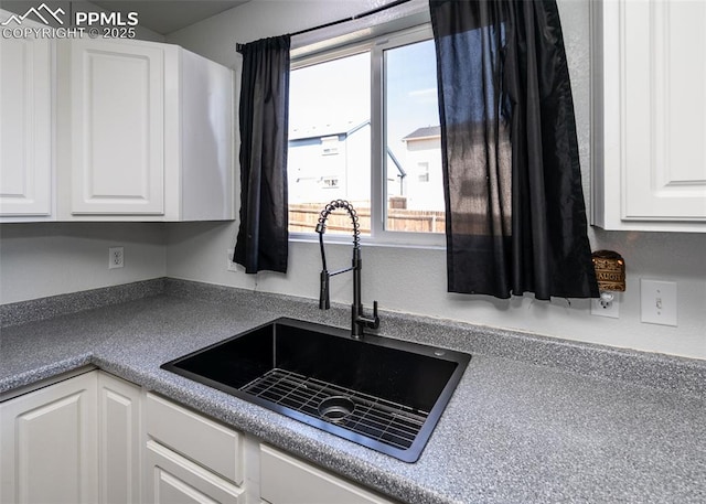 1536 Ancestra Dr, Fountain, CO 80817 - kitchen with a sink, a wealth of natural light, and white cabinets