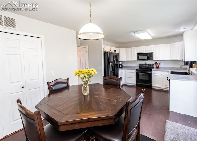 1536 Ancestra Dr, Fountain, CO 80817 - dining space with dark wood-style flooring and visible vents