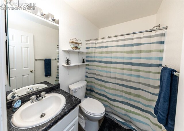 1536 Ancestra Dr, Fountain, CO 80817 - bathroom featuring toilet, curtained shower, and vanity