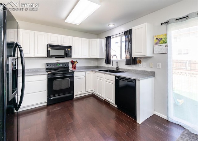1536 Ancestra Dr, Fountain, CO 80817 - kitchen featuring dark wood-type flooring, white cabinets, a sink, and black appliances