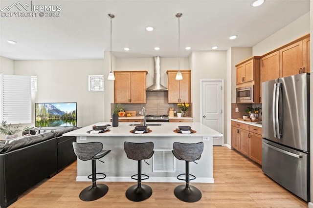 48 Mayflower Park Pl, Colorado Springs, CO 80905 - kitchen featuring stainless steel appliances, wall chimney exhaust hood, a sink, open floor plan, and a breakfast bar area