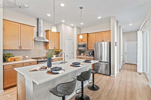 48 Mayflower Park Pl, Colorado Springs, CO 80905 - kitchen with appliances with stainless steel finishes, wall chimney exhaust hood, light wood-style flooring, tasteful backsplash, and recessed lighting