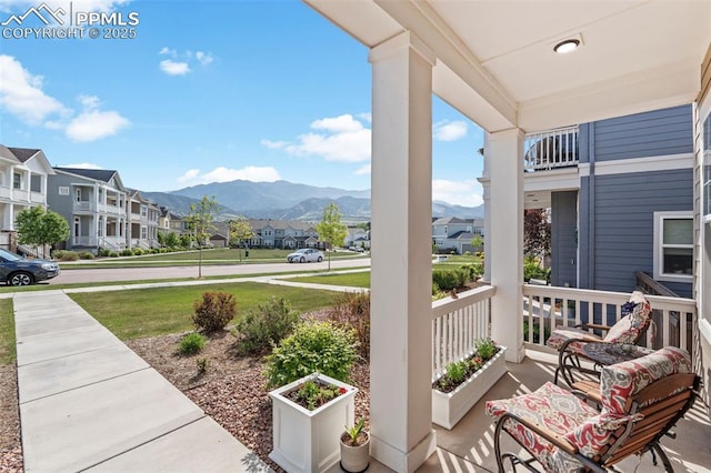 48 Mayflower Park Pl, Colorado Springs, CO 80905 - porch featuring a residential view, a mountain view, and a yard