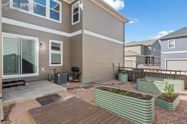 48 Mayflower Park Pl, Colorado Springs, CO 80905 - wooden terrace featuring cooling unit, a patio, a vegetable garden, and a gate