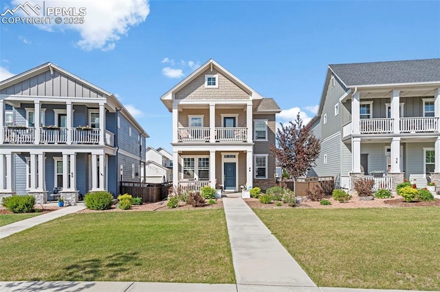 48 Mayflower Park Pl, Colorado Springs, CO 80905 - view of front facade featuring covered porch, a balcony, board and batten siding, and a front lawn