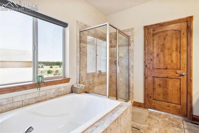 full bathroom featuring a shower stall and a garden tub