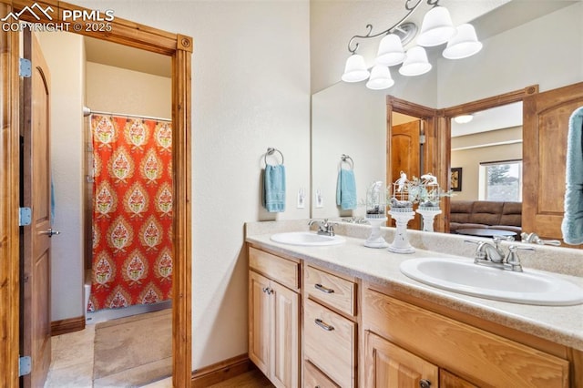 bathroom featuring a shower with shower curtain, a sink, and double vanity