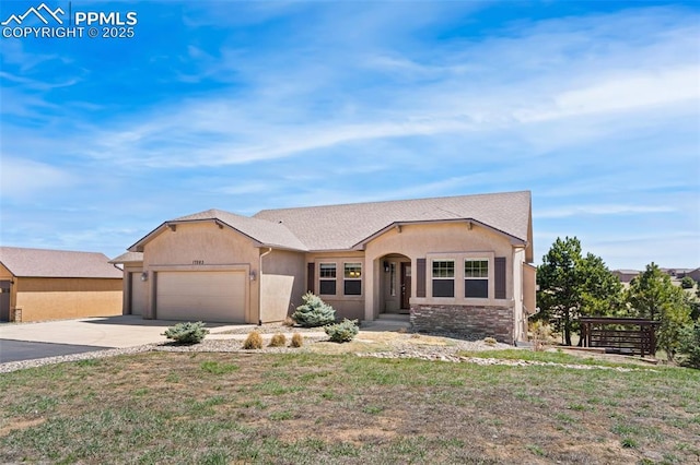 ranch-style home featuring stucco siding, an attached garage, and driveway