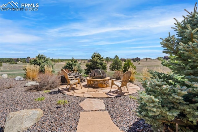 view of yard with an outdoor fire pit and a patio