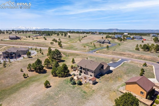 bird's eye view featuring a rural view and a mountain view