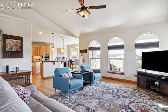 living area featuring lofted ceiling, recessed lighting, light wood-style floors, and ceiling fan
