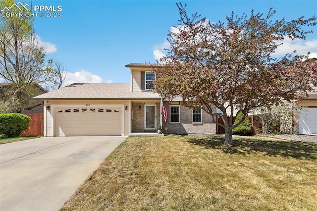 620 Jayton Dr, Colorado Springs, CO 80911 - traditional-style home featuring a front lawn, driveway, fence, brick siding, and an attached garage