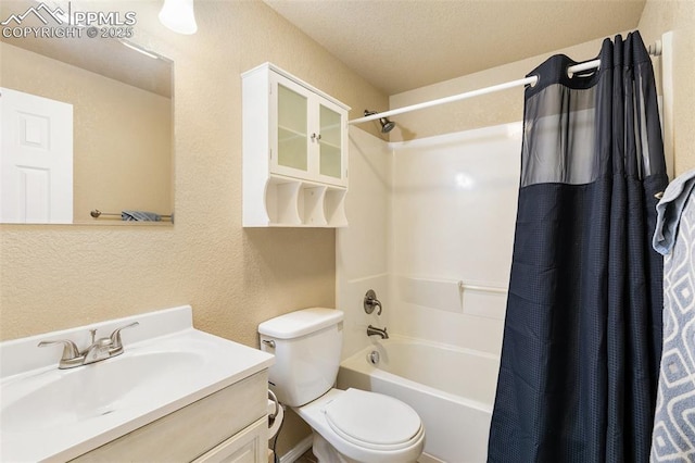 620 Jayton Dr, Colorado Springs, CO 80911 - full bathroom featuring toilet, a textured wall, vanity, and shower / tub combo with curtain