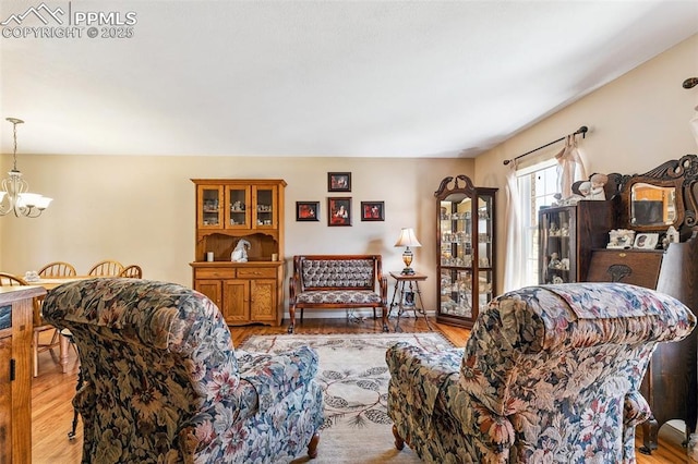 620 Jayton Dr, Colorado Springs, CO 80911 - living room featuring wood finished floors and a notable chandelier