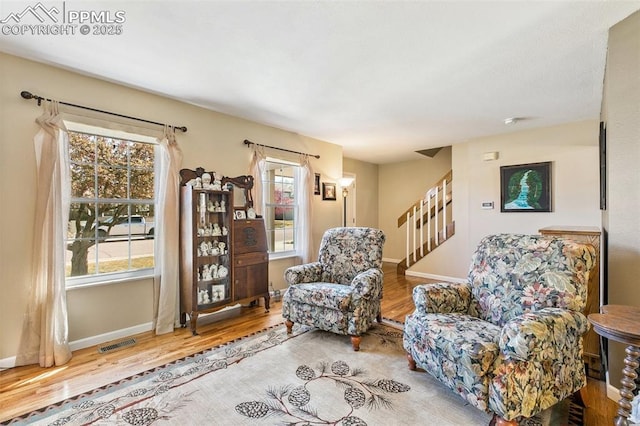 620 Jayton Dr, Colorado Springs, CO 80911 - sitting room with visible vents, baseboards, wood finished floors, and stairway