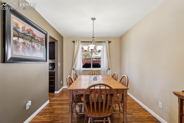 620 Jayton Dr, Colorado Springs, CO 80911 - dining room featuring wood finished floors, baseboards, and a notable chandelier