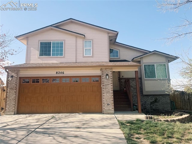 8246 Pinegate Dr, Colorado Springs, CO 80925 - view of front of home featuring brick siding, an attached garage, and concrete driveway