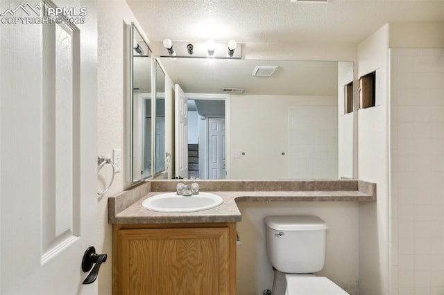 8246 Pinegate Dr, Colorado Springs, CO 80925 - full bath featuring vanity and a textured ceiling