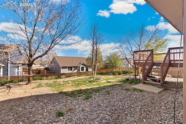 8246 Pinegate Dr, Colorado Springs, CO 80925 - fenced backyard with a wooden deck and stairway