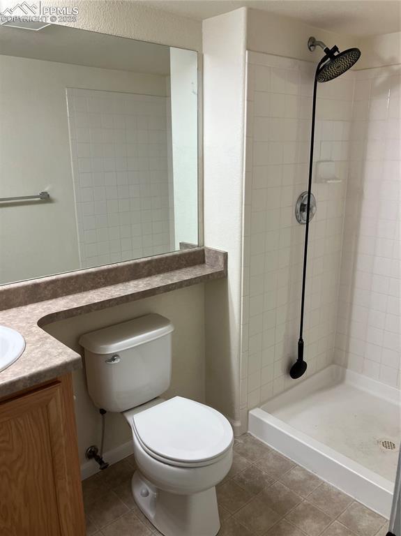8246 Pinegate Dr, Colorado Springs, CO 80925 - bathroom with vanity, a stall shower, and tile patterned floors