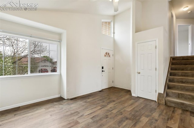 8246 Pinegate Dr, Colorado Springs, CO 80925 - foyer featuring wood finished floors, stairs, ceiling fan, and a towering ceiling