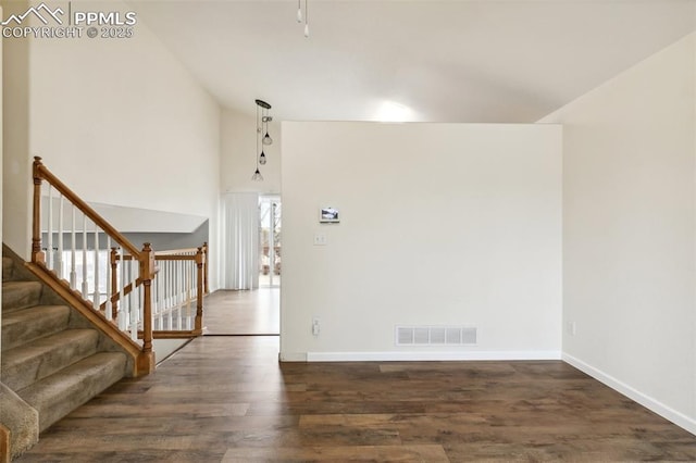 8246 Pinegate Dr, Colorado Springs, CO 80925 - foyer entrance featuring wood finished floors, a towering ceiling, and stairs