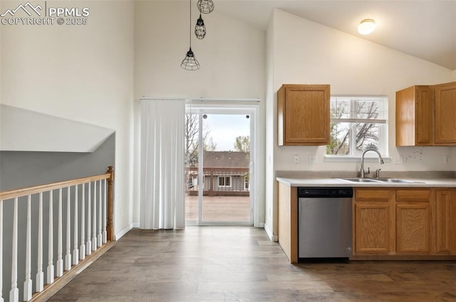 8246 Pinegate Dr, Colorado Springs, CO 80925 - kitchen featuring dishwasher, high vaulted ceiling, wood finished floors, and light countertops