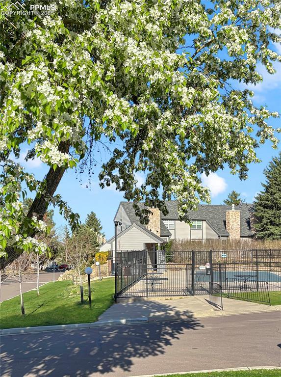 422 Cobblestone Dr, Colorado Springs, CO 80906 - exterior space with fence, a gate, and a lawn