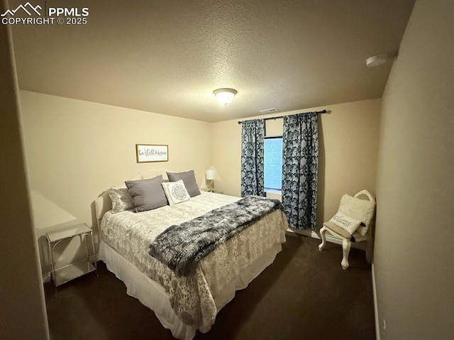 10088 Stonemont Dr, Peyton, CO 80831 - bedroom featuring dark carpet, a textured ceiling, and visible vents