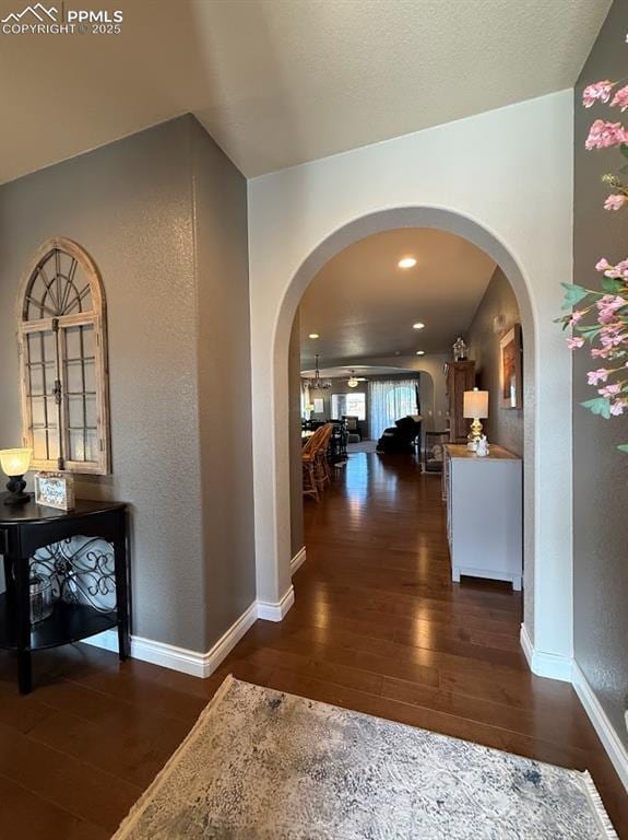 10088 Stonemont Dr, Peyton, CO 80831 - hall featuring arched walkways, baseboards, hardwood / wood-style flooring, and a textured wall