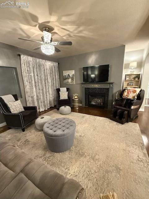 10088 Stonemont Dr, Peyton, CO 80831 - living area with a fireplace, wood finished floors, and ceiling fan