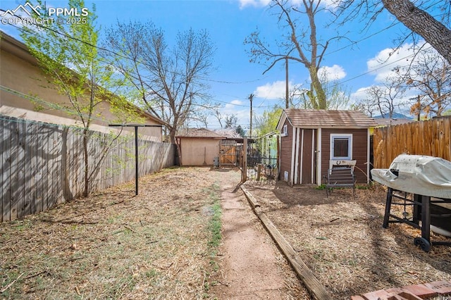 1903 W Colorado Ave, Colorado Springs, CO 80904 - view of yard with a fenced backyard, an outbuilding, and a storage shed
