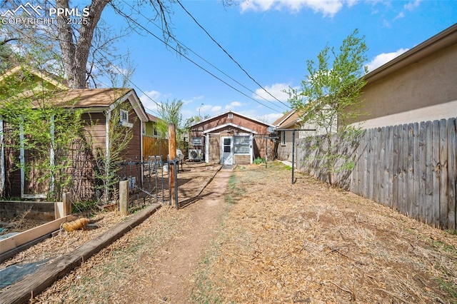 1903 W Colorado Ave, Colorado Springs, CO 80904 - view of yard featuring an outdoor structure, a vegetable garden, and fence