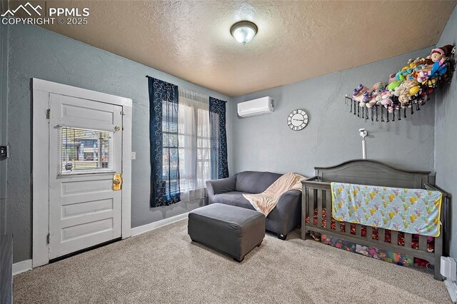 1903 W Colorado Ave, Colorado Springs, CO 80904 - bedroom with a textured ceiling, a textured wall, baseboards, carpet flooring, and a wall unit AC