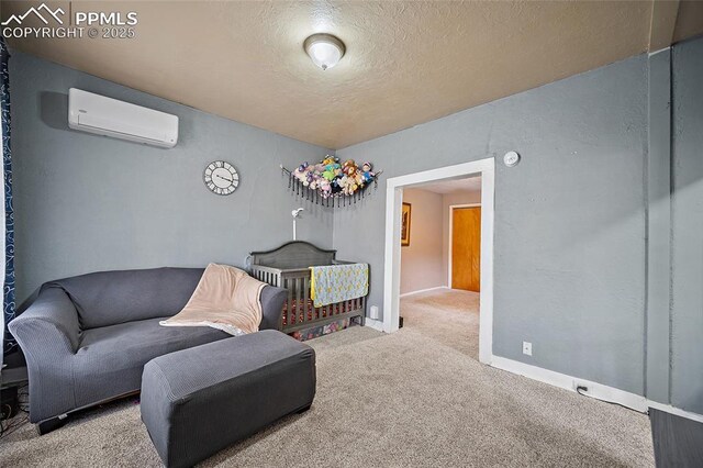 1903 W Colorado Ave, Colorado Springs, CO 80904 - sitting room with baseboards, an AC wall unit, a textured ceiling, and carpet flooring