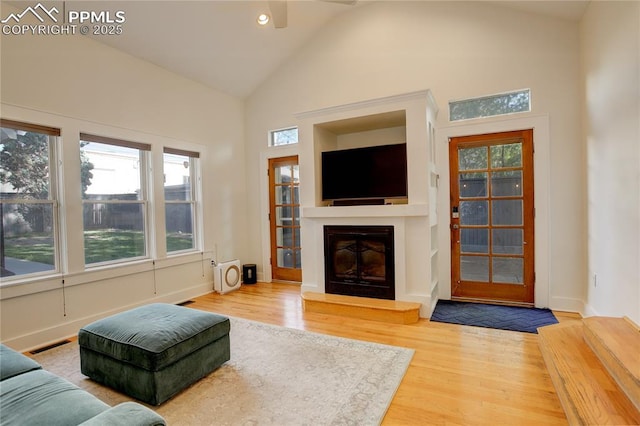 1866 S Pennsylvania St, Denver, CO 80210 - living area with a glass covered fireplace, wood finished floors, a ceiling fan, high vaulted ceiling, and recessed lighting