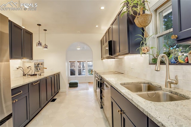 1866 S Pennsylvania St, Denver, CO 80210 - kitchen with range, white microwave, tasteful backsplash, recessed lighting, and light tile patterned floors