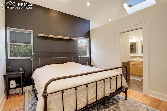 1866 S Pennsylvania St, Denver, CO 80210 - bedroom with a skylight, recessed lighting, light wood finished floors, an accent wall, and ensuite bathroom