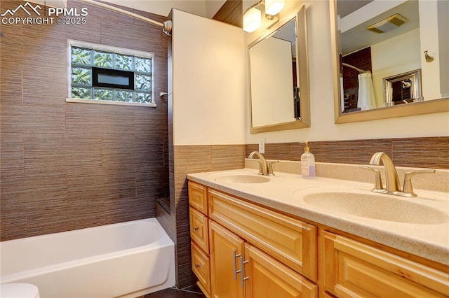 1866 S Pennsylvania St, Denver, CO 80210 - full bathroom featuring tile walls, double vanity, shower / tub combo with curtain, and a wainscoted wall