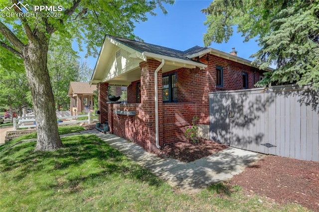 1866 S Pennsylvania St, Denver, CO 80210 - view of side of property featuring brick siding, a chimney, and covered porch