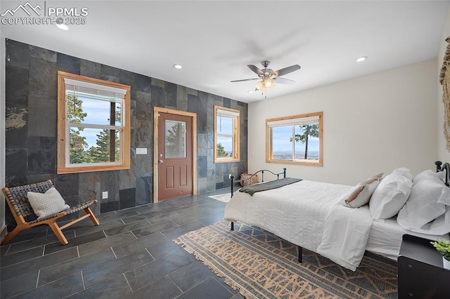 bedroom with a ceiling fan, tile walls, and recessed lighting