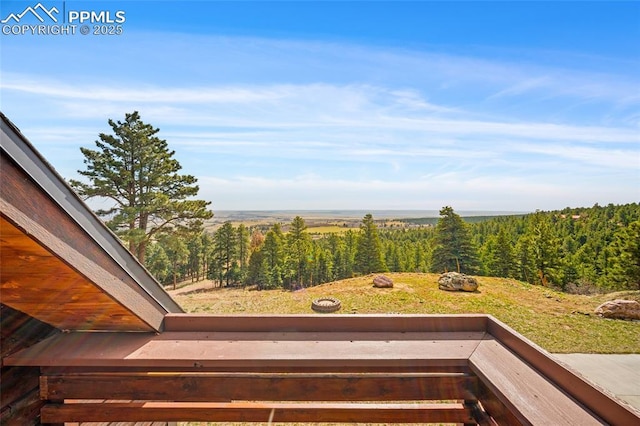 view of yard with a view of trees