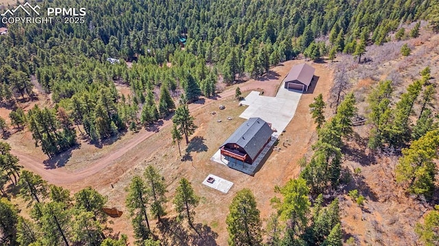 birds eye view of property with a forest view