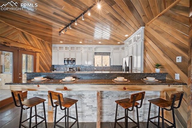 kitchen featuring wooden ceiling, french doors, rail lighting, and stainless steel appliances