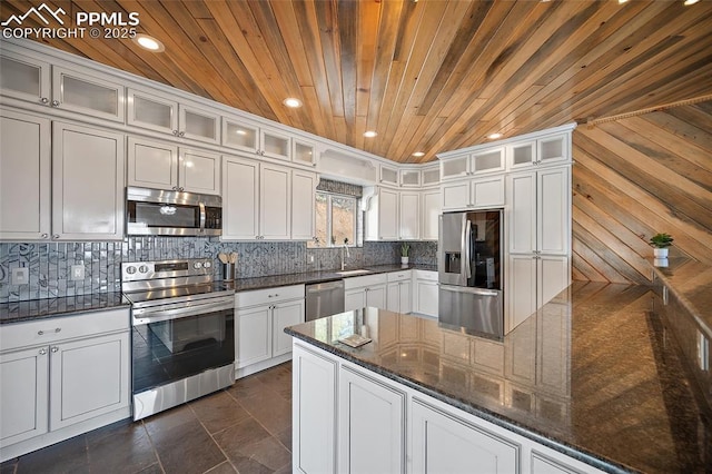 kitchen featuring white cabinets, appliances with stainless steel finishes, wood ceiling, and a sink